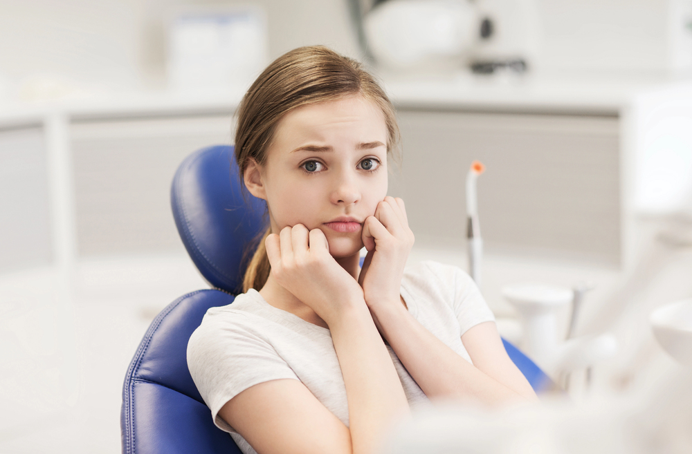 young woman fearful in the dental chair